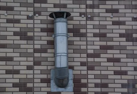 Vent system hanging on the brick wall Stock Photos