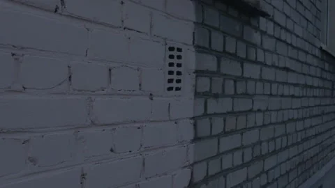 Ventilation Brick Inserted into the Wall of a Gray Brick House Stock Footage 293258065