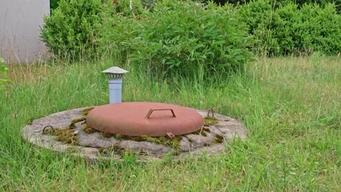 Ventilation Cap and Rusty Hatch Lid Covering Entrance to Underground Bunker Stock Footage 278272350