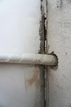The ventilation duct wire from the pierced wall. Internal communications. Stock Photos