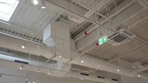 Ventilation ducts air conditioning and emergency exit sign on commercial ceiling Stock Footage 342913949