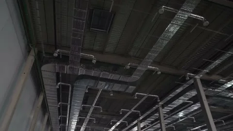 Ventilation ducts inside a large warehouse under construction. Stock Footage 218471499