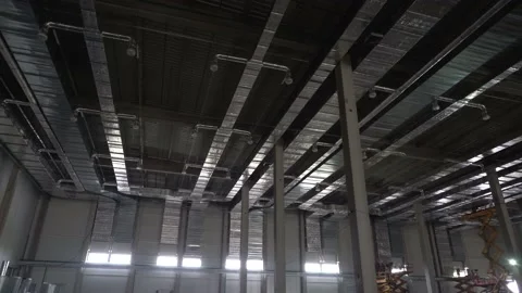 Ventilation ducts of large warehouse under construction reflecting at water Stock Footage 218471554