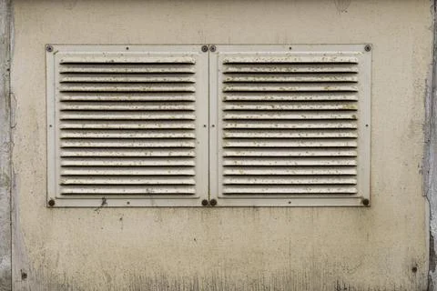 The ventilation grill is installed on a cement wall Stock Photos