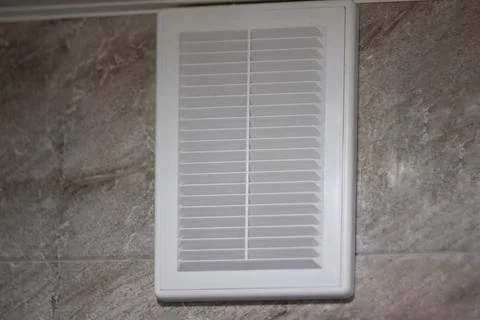 Ventilation grille in white on gray marble tiles Stock Photos