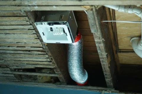 Ventilation with light is installed into a ceiling. Stock Photos