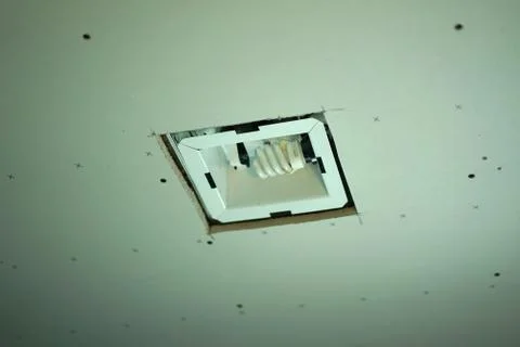 Ventilation with light is installed into a ceiling. Stock Photos