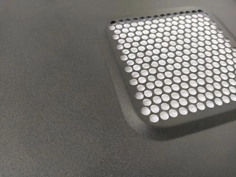 Ventilation mesh of the computer. Metal surface with round numerous holes Foto stock