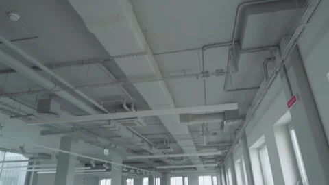 Ventilation pipes inside an empty office building. Gimbal shot Stock Footage 249963226