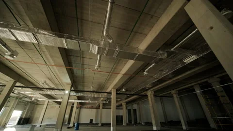 Ventilation pipes in silver insulation material hanging from the ceiling inside  Stock Footage 228147945