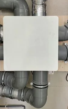 Ventilation system with gray pipes and insulation detail for modern building Stock Photos