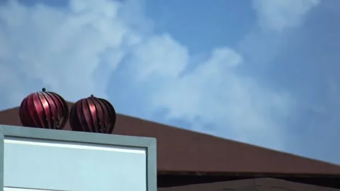 Ventilation system. Two metallic spherical turbines on building roof, expansive Stock Footage 335763692