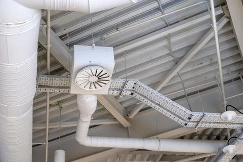 Ventilation system under ceiling of modern warehouse or shopping center. Metal Stock Photos