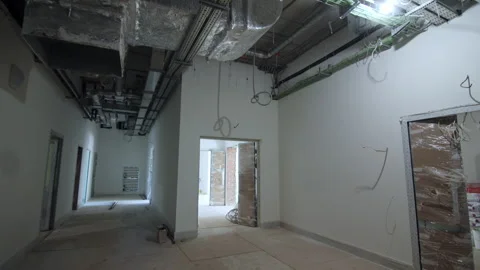 Ventilation systems hang above messy plywood floor panels Stock Footage 335644428