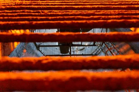 The ventilation well of the underground tunnel through the fence grate in mix Stock Photos
