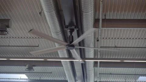 Ventilation. A working fan on the ceiling in a warehouse. Stock Footage 310969029