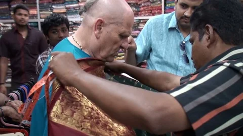 Ventors recommending the best type of material fot sewing the men's dress Stock Footage 78699841