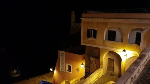 Ventotene, Ancient house on the small ancient roman marina, lighthouse at night Stock Footage 120744869