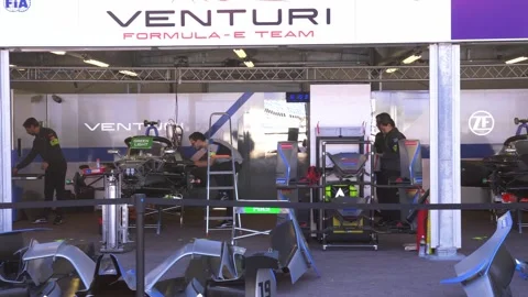 Venturi Formula E Team garage with mechanics preparing electric race cars  in 4K Video stock 323204326