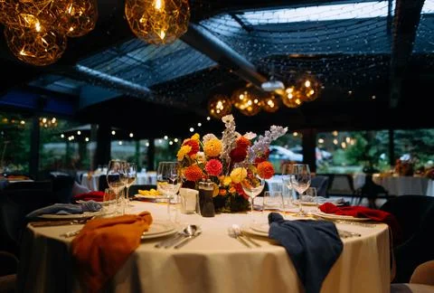 Venue for a wedding reception with decor, selective focus on tables and decor Stock Photos