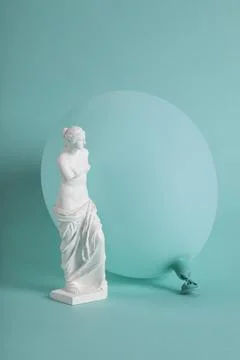 A Venus de Milo in front of a turquoise balloon in the same color as the ba.. Stock Photos