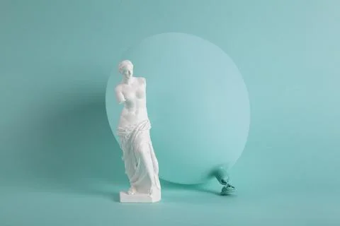 A Venus de Milo in front of a turquoise balloon in the same color as the ba.. Stock Photos