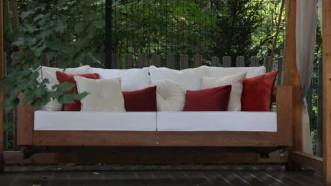 Veranda with garden swing is decorated with fall decor and chrysanthemums 動画素材 282202856