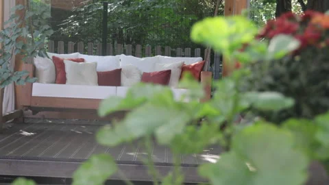 Veranda with garden swing is decorated with fall decor and chrysanthemums Stock-Footage 282239313