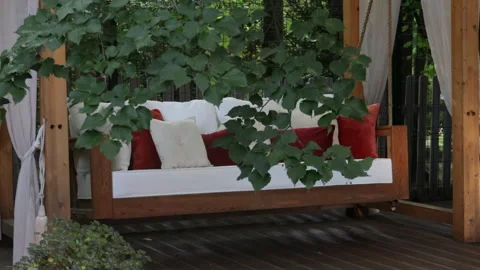 Veranda with garden swing is decorated with fall decor and chrysanthemums Stock-Footage 282239334