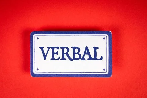 VERBAL. Text on white sticky note. Red background Stock Photos
