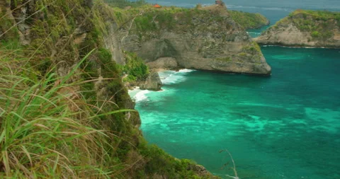 Verdant Cliffs Tower Over Blue Ocean At Diamond Beach In Nusa Penida Bali Island Stock-Footage 342769930