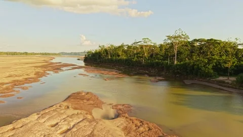 Verdant foliage lining dry riverbed, highlighting ecological shifts in Ecuador 스톡 동영상 308411777