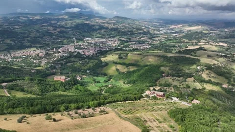 Verdant hills, patchwork fields, and serene towns of the Marche region in Italy, Stock Footage 330376298