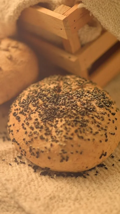 Verical close-up hd slow motion video of homemade bread on a rustic background. Stock Footage 133442109