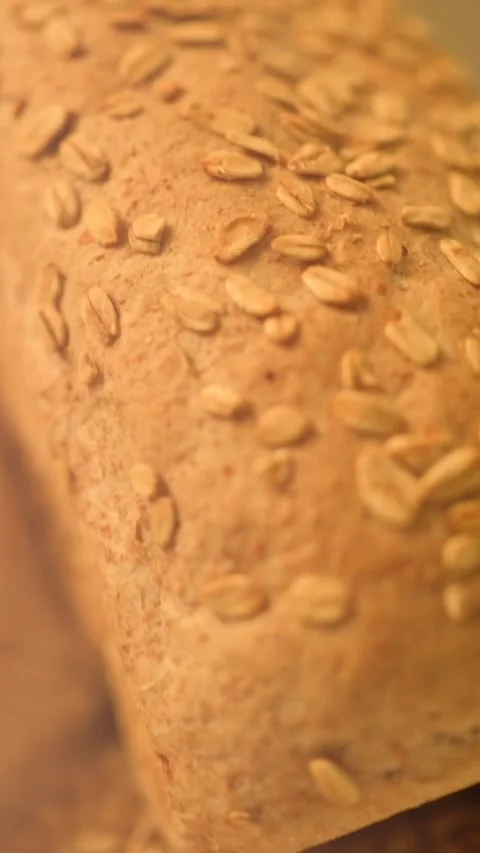 Verical close-up hd slow motion video of homemade bread on a rustic background. Stock Footage 134062309