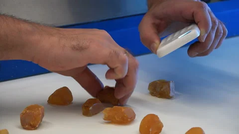 Verification of the authenticity of the stone with an ultraviolet flashlight Stock Footage 92899771