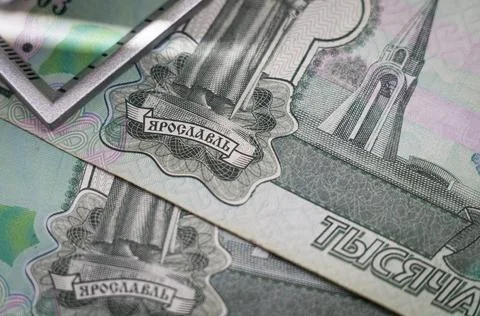 Verification of Russian banknotes for authenticity under a magnifying glass Stock Photos
