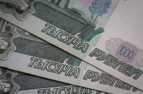 Verification of Russian banknotes for authenticity under a magnifying glass Stock Photos