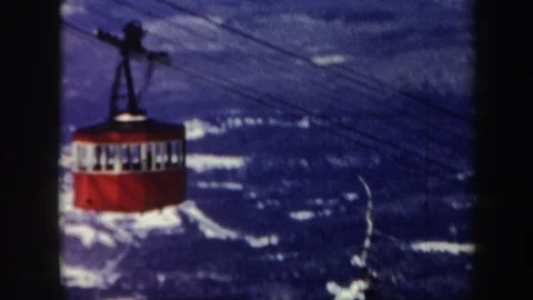 VERMONT-1962: Red Cable Car Makes Its Slow Journey Through The Icy Mountains Stock Footage 127490595
