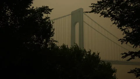 Verrazano Bridge Through the Trees Engulfed in Smoke from Canadian Wildfires Stock Footage 243228667