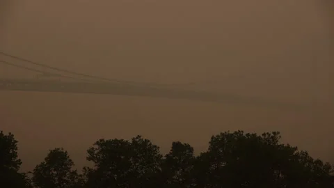 Verrazano Narrows Bridge Deck Engulfed in Smoke from Canadian Wildfires Stock Footage 243228194