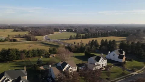 Versatile drone footage flying over a small town and highschool with tennis  Stock Footage 228700146