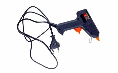 Versatile glue gun ready for various crafting and repair tasks in a well-li.. Stock-Fotos