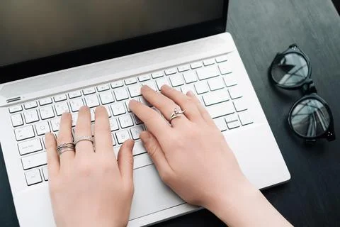Versatile Work Environment. Woman's Hands Typing on Computer Keyboard in Office Stock Photos