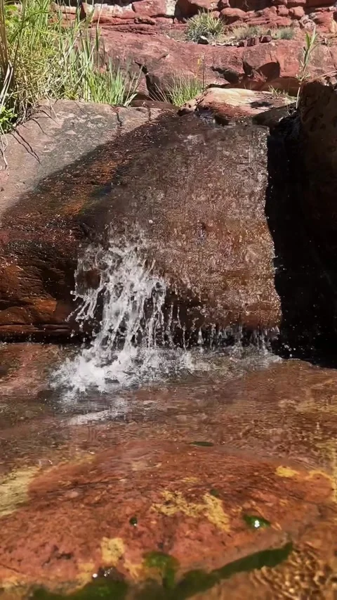 Vert View Of Water Flowing Over Boulder On Oak Creek In Sedona Stock Footage 346819266