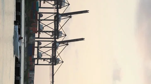 Vertcal (9:16) shot of tall cranes on Maimi harbor in early evening Stock Footage