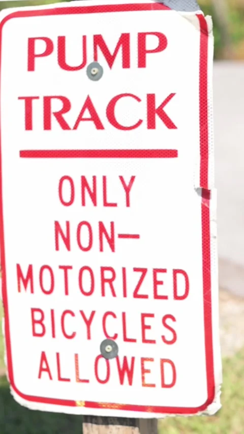 Verti al screen angled pump track sign Johnson City park near trailhead, bold Stock Footage 325753568