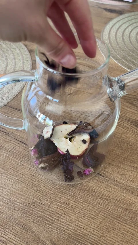 Vertical 4K Adding Dried Apples Plums Rosebuds Spices Glass Teapot Winter Tea Stock-Footage 347098250
