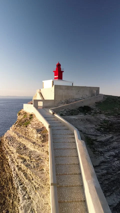Vertical 4K Aerial Shot of a Lighthouse at Sunrise Stock Footage 331654728