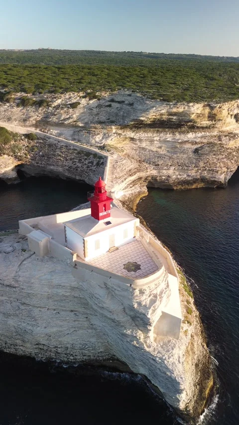 Vertical 4K Aerial Shot of a Lighthouse at Sunrise Stock Footage 331654809